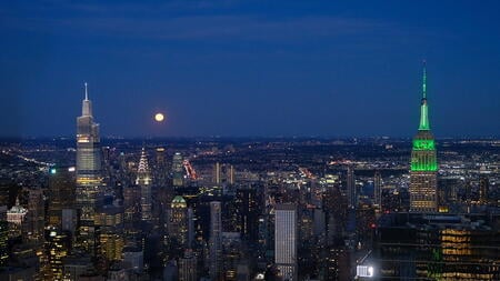 New York City lit up green for Climate Week NYC, with iconic buildings shining bright for climate action.