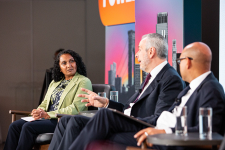 Speakers in conversation on stage