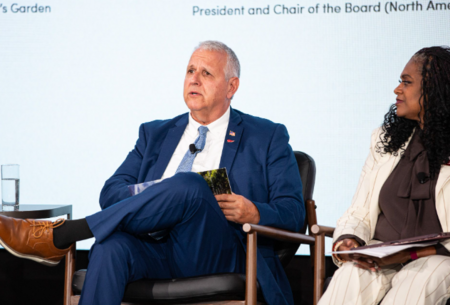 Gary Locco speaking on stage