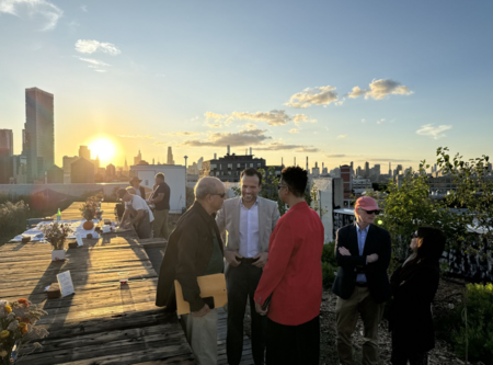 People gather on roof at sunset